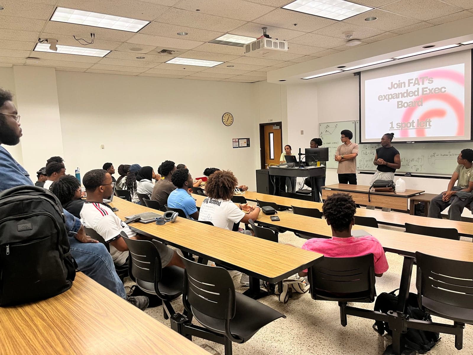 NSBE members collaborating at a general body meeting with NSBE written on the whiteboard