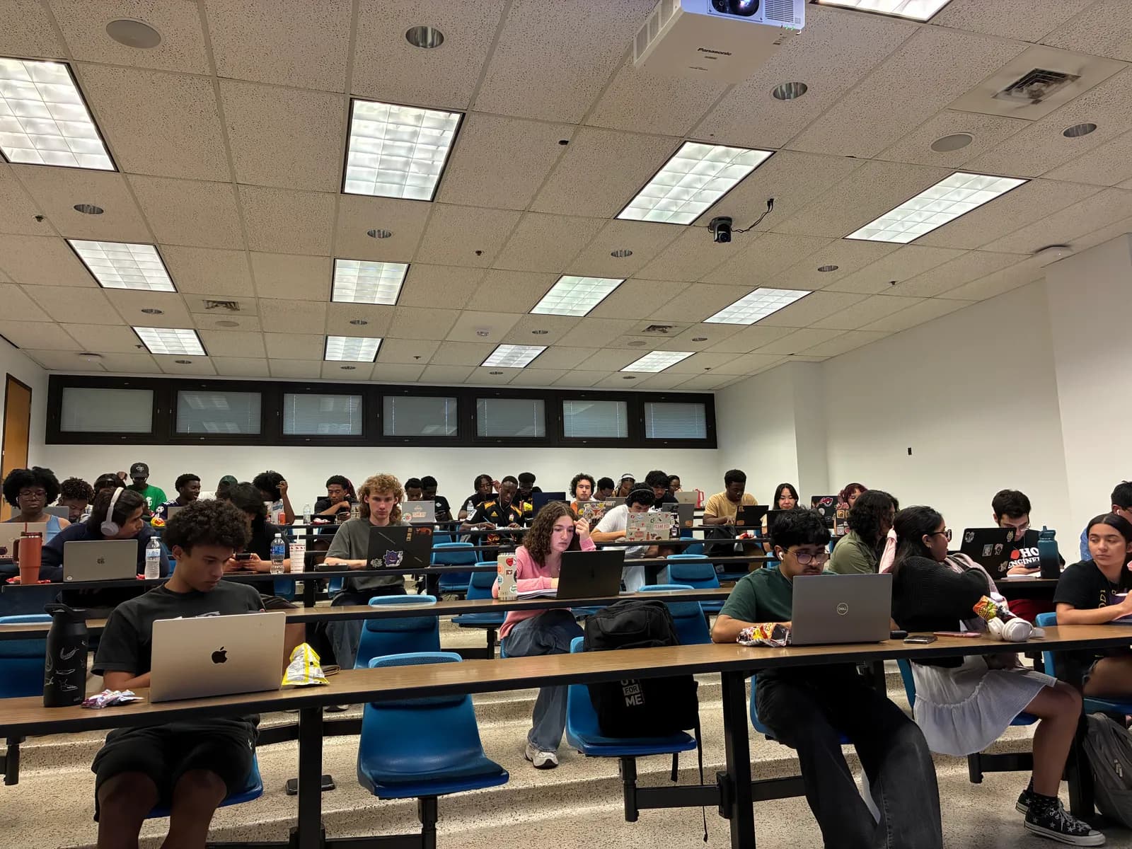 A lecture hall filled with NSBE members studying at laptops during a SNAP study night